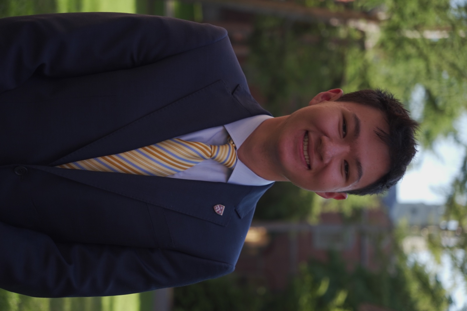 Carl Chen outdoors in a suit and tie